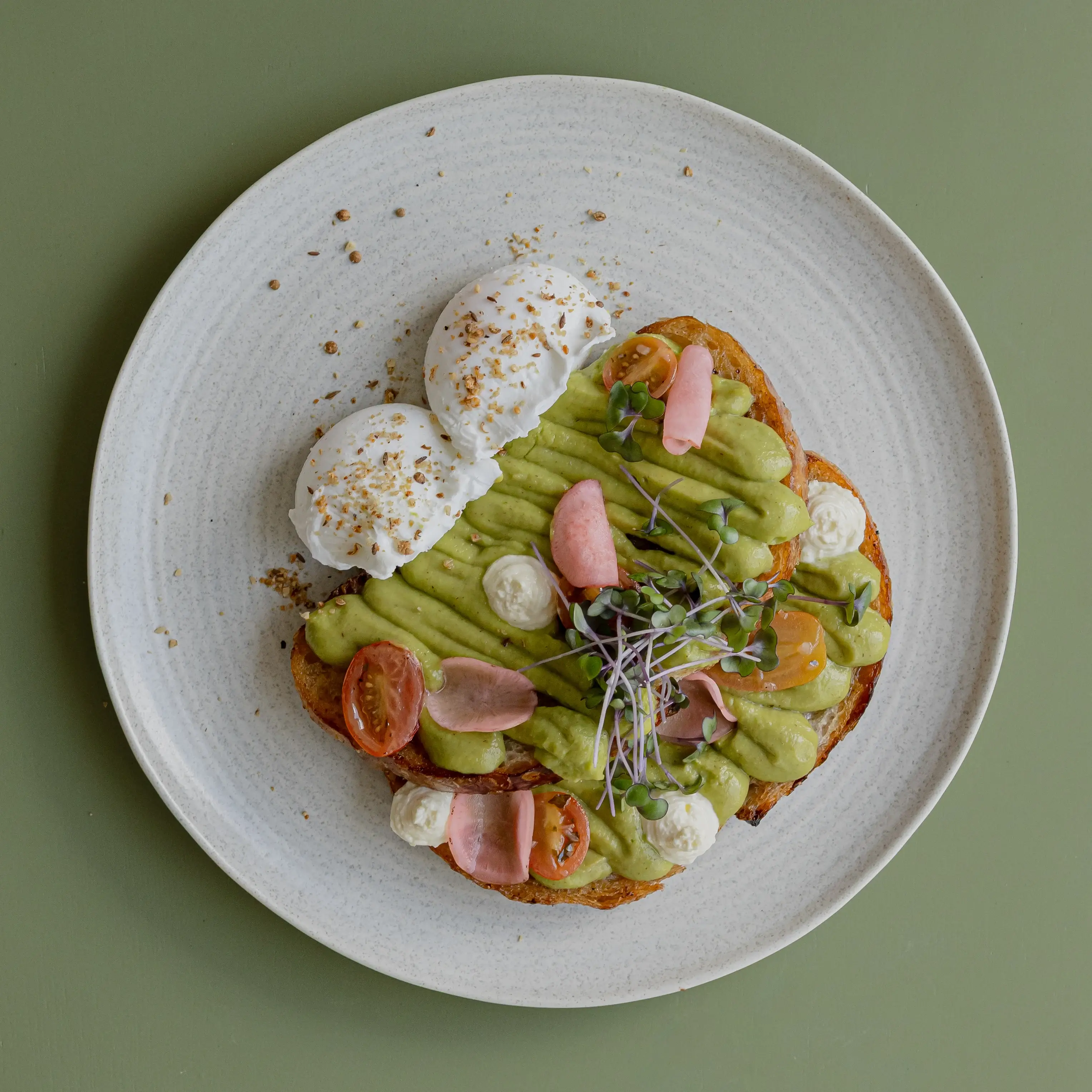 Avo toast on sourdough, cherry tomatoes, whipped feta, toasted dukkha, pached eggs